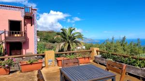 a table and chairs on the balcony of a house at Celeste in Mazo