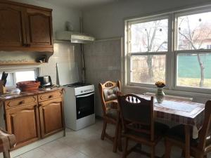 a kitchen with a table and a stove top oven at Casuta Sanatatii in Covasna