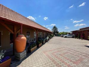 a building with a large vase on the side of it at Vadvirág Vendéglő és Panzió in Tatabánya