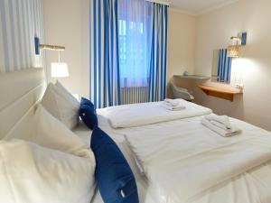 Ein Bett oder Betten in einem Zimmer der Unterkunft Dünenpark Binz - WG 73 "Strandläufer" mit Terrasse