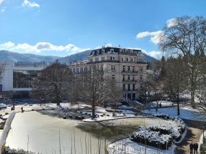 a building with a pond in front of a building at Hotel Löhr in Baden-Baden +131 photos