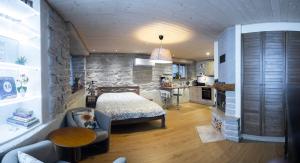a bedroom with a bed and a stone wall at Saue 1 Apartment in Tallinn