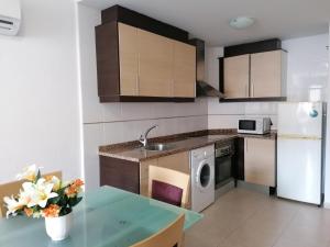 a kitchen with a sink and a stove at Miralcielo Planta Baja LEK in Peñíscola
