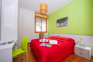 a bedroom with a red bed and green walls at Appartamenti Secrel in Tremosine Sul Garda