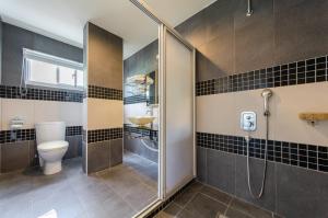a bathroom with a shower with a toilet and a sink at Lanhiwan Inn in Nanwan