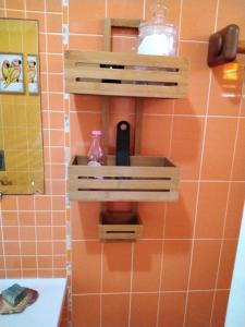 a bathroom with a shelf on a tiled wall at Manta Rota Beach, apartment in a villa, terrace,garden in Manta Rota +17 photos