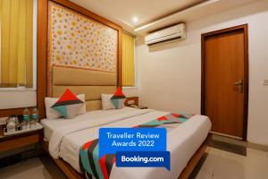 a hotel room with a bed and a window at FabHotel Baba Residency in New Delhi