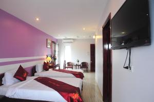 
Ein Bett oder Betten in einem Zimmer der Unterkunft Hong Thien Ruby Hotel
