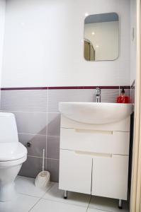 a bathroom with a white sink and a toilet at Park Hotel in Uman +49 photos