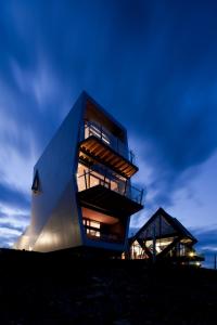 a building on top of a hill at night at MONA Pavilions in Hobart