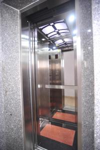 a elevator in a building with a glass door at Hong Thien Ruby Hotel in Hue