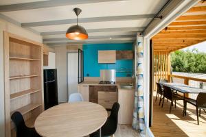 a kitchen and dining room with a table and chairs at Camping la Croix du Sud in Saint-Tropez