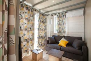 a living room with a couch and a table at Camping la Croix du Sud in Saint-Tropez