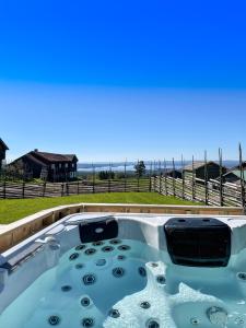 a hot tub with a view of the ocean at Brudtallen in Fryksås