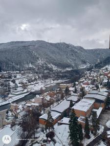 a town covered in snow with a mountain in the background at stan na dan IM in Užice