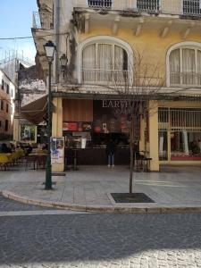 a building with a bar on the side of a street at DORA'S APARTMENTS STUDIO 1 in Corfu Town
