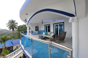 a balcony of a house with a swimming pool at casaenjoysamana in Los Naranjos