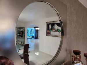 a large round mirror in a living room at casaenjoysamana in Los Naranjos