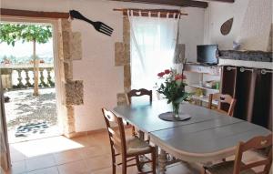 a dining room with a table and chairs and a window at Nice Home In Lavardac With 4 Bedrooms And Wifi in Lavardac
