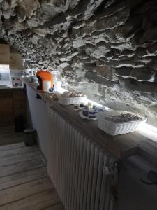a kitchen with a stone wall and a radiator at Il Teggiolo in Varzo