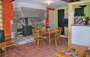 ein Esszimmer mit einem Tisch und einem Kamin in der Unterkunft Pet Friendly Home In Brhand With Wifi in Moncontour