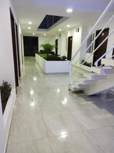 a hallway of a building with a staircase and a floor at Hostal Las Orquideas in Manta
