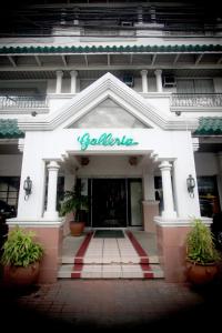 a white building with a sign on the front of it at Hotel Galleria in Davao City