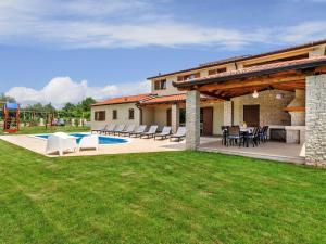 a patio with a table and chairs in a yard at Holiday Home Jadran - LBN310 by Interhome in Nedeščina