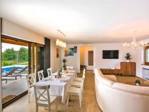 a dining room and living room with a table and a couch at Holiday Home Jadran - LBN310 by Interhome in Nedeščina