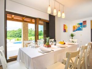 a dining room with a white table and chairs at Holiday Home Jadran - LBN310 by Interhome in Nedeščina