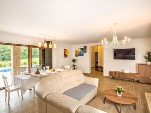 a living room with a white couch and a dining room at Holiday Home Jadran - LBN310 by Interhome in Nedeščina