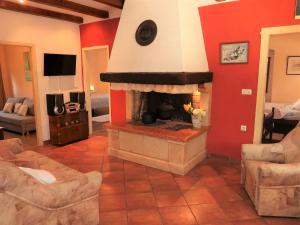 a living room with a fireplace with red walls at Holiday Home Nino - LBN305 by Interhome in Kršan
