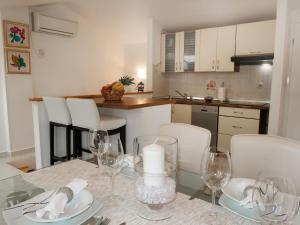 a kitchen with a table with a candle and glasses at Apartment Marinella - LBN120 by Interhome in Labin
