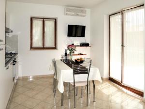 a kitchen and dining room with a table and chairs at Apartment Danica by Interhome in Rabac