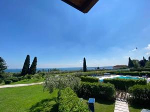 a view of a garden and a swimming pool at Residence Corte Ferrari -Ciao Vacanze- in Moniga