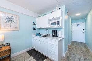 a kitchen with a sink and a microwave at I Need A Vacay Now! Remodeled Studio in Daytona Beach