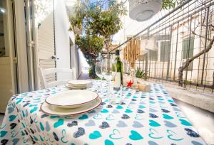 a table with a blue and white table cloth on a balcony at Nido Lungomare, e sei in spiaggia... in Cala Gonone