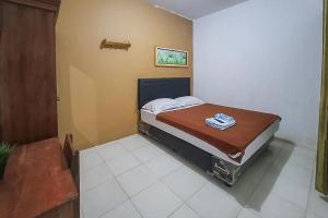 una piccola camera con un letto in una stanza di Syafa Homestay Syariah Mitra RedDoorz a Jembel
