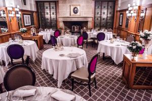 a dining room with white tables and purple chairs at Hotel Restaurant Chavant in Bresson