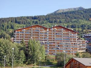 a large apartment building in the middle of a mountain at Apartment Christiania 2 O1 by Interhome in Nendaz