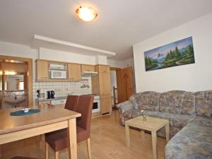 a living room with a couch and a table at Apartment Handle-2 by Interhome in Ried im Oberinntal