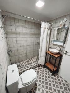 a bathroom with a toilet and a sink at Bella Vista 2! in Esquel