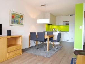 a kitchen and dining room with a table and chairs at Apartment Allod Park Haus C 604 by Interhome in Davos +34 photos