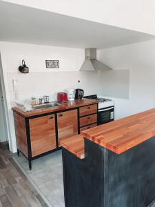 a kitchen with a sink and a stove at Bella Vista 2! in Esquel