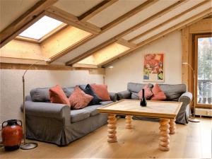a living room with a couch and a coffee table at Apartment Chesa Misaun by Interhome in Pontresina +22 photos