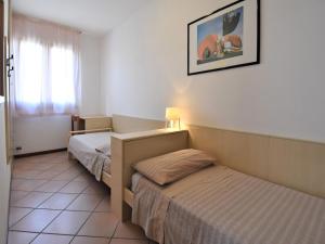 a hotel room with two beds and a window at Holiday Home Mediterraneo by Interhome in Rosapineta