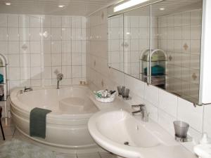 a bathroom with a tub and a sink and a mirror at Apartment Mahlke by Interhome in Klein Belitz