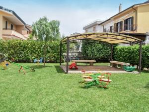 a playground with a picnic table and chairs in the grass at Apartment Casale Cilento-1 by Interhome in Paestum