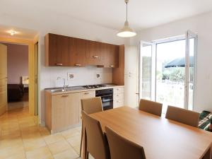 a kitchen and dining room with a wooden table at Apartment Casale Cilento-1 by Interhome in Paestum +18 photos