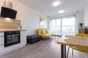 a living room with a table and a living room with a fireplace at Yellow apartment with PARKING in Prague